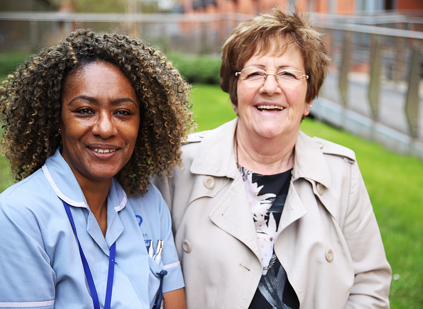 Healthcare professional supporting an older woman